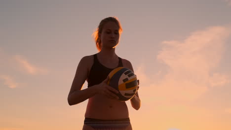 Young-girl-jump-serve-volleyball-on-the-beach-slow-motion